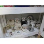 A shelf of commemorative china etc