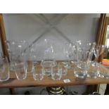 A shelf of glassware including 3 water jugs,