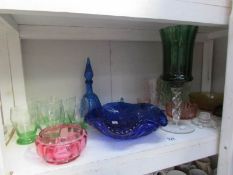 A shelf of coloured glass