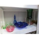 A shelf of coloured glass