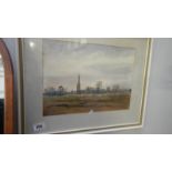 A framed and glazed rural scene with village in distance