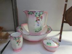 A jug and basin set with soap dish and toothbrush jar