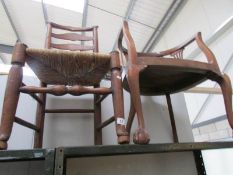 A ladder back chair and an elbow chair on ball and claw feet