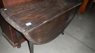 An old drop leaf table with carved edge (has chip on one foot)