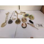 A mixed lot of pendants and brooches