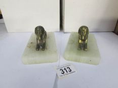 A pair of Sphinx book ends on alabaster bases