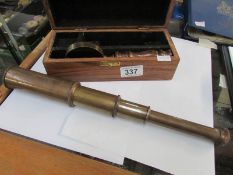 A cased brass telescope with magnifying glass