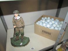 A golfer door stop and a box of golf balls