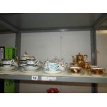 A shelf of assorted tea ware