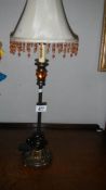 A table lamp with beaded shade