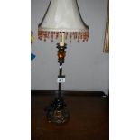 A table lamp with beaded shade