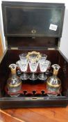A boxed decanter set with glasses and bottles