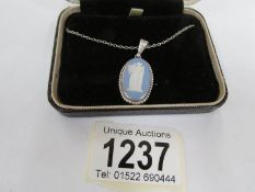 A Wedgwood cameo pendant set in silver and on silver chain