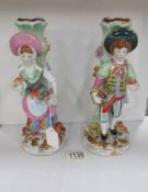 A pair of continental porcelain figural spill vases