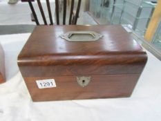 A rosewood box with inset handle to lid