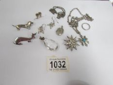 A mixed lot of silver jewellery including silver dachsund brooches, star brooch, chains,