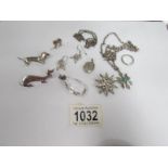 A mixed lot of silver jewellery including silver dachsund brooches, star brooch, chains,
