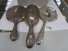 2 silver backed hand mirrors and a silver backed hair brush