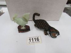 A jade cockerel and a beadwork lizard