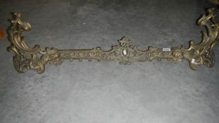 A pair of French brass 'Chenet' with connecting bar