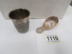 A silver caddy spoon and a silver 'Just a thimble full' spirit measure