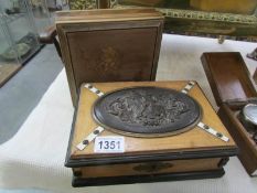 A box with oval bronzed plaque and one other