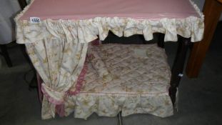 A dolls four poster bed