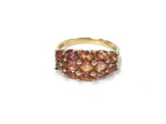 A 9ct gold ring set pink stones, stamped 375,