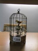 An automated bird in cage clock