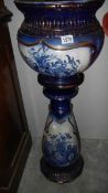 A blue and white jardiniere on stand