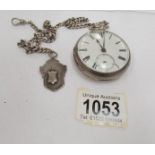 A silver pocket watch on chain with silver fob