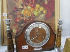 A mantel clock and a pair of wood & metal candlesticks