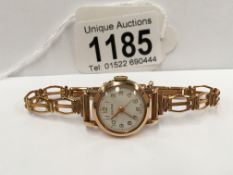 A Baume ladies 9ct gold watch and strap