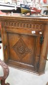 An oak corner cupboard