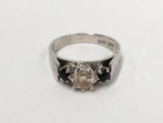 An 18 carat gold quarter carat central diamond flanked by 2 sapphires ring,