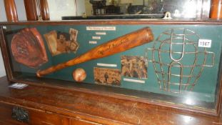 A baseball bat and related ephemera in a glass case