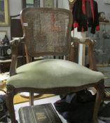 A cane backed elbow chair