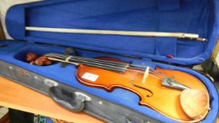 A cased violin with bow