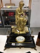 A marble based clock surmounted bronze figure of a lady with butterfly,
