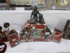 A French marble clock garniture surmounted girl with cat,
