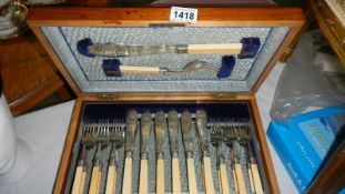 A cased set of fish cutlery