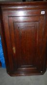 An oak corner cupboard