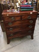 A 2 over 3 mahogany chest of drawers on splay feet
