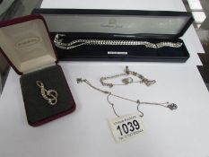 2 silver necklaces, a silver bracelet and a silver clef brooch,