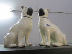 A pair of pottery pug dogs