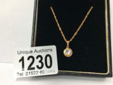 An 18ct gold stone set pendant on an 18ct gold chain