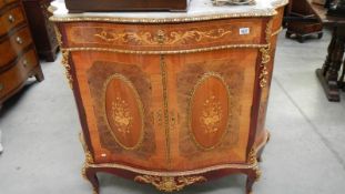 An ormolu mounted marble topped cabinet