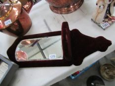 A Victorian velour covered bevel edged mirror with shelf