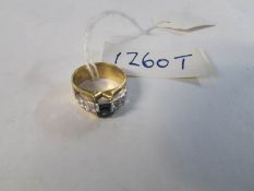 A 14ct gold ring with 15 small diamonds (1 missing) and a sapphire