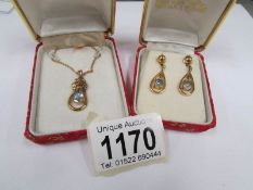 A matching 9ct gold and aquamarine pendant and earrings with insurance certificate